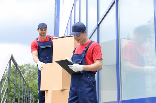 Team of professional movers unloading in new office space